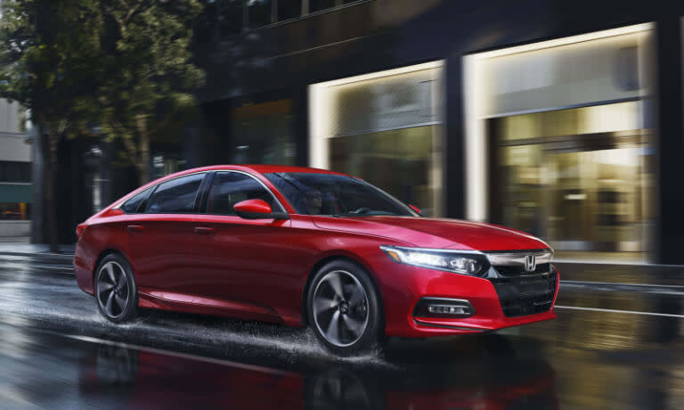 2019 Honda Accord driving on wet city street at night