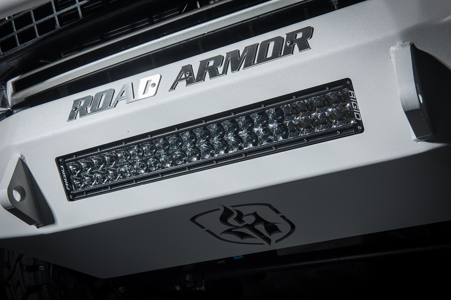 road armor super duty stealth bumper with rigid lights and kevlar coating on a white platinum f-350 ford