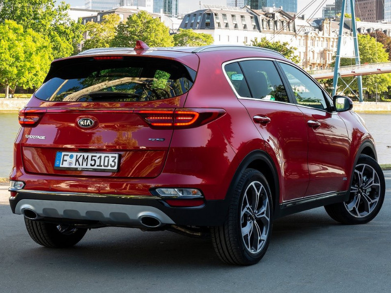 Back side Exterior of a red 2019 Kia Sportage parked by a river