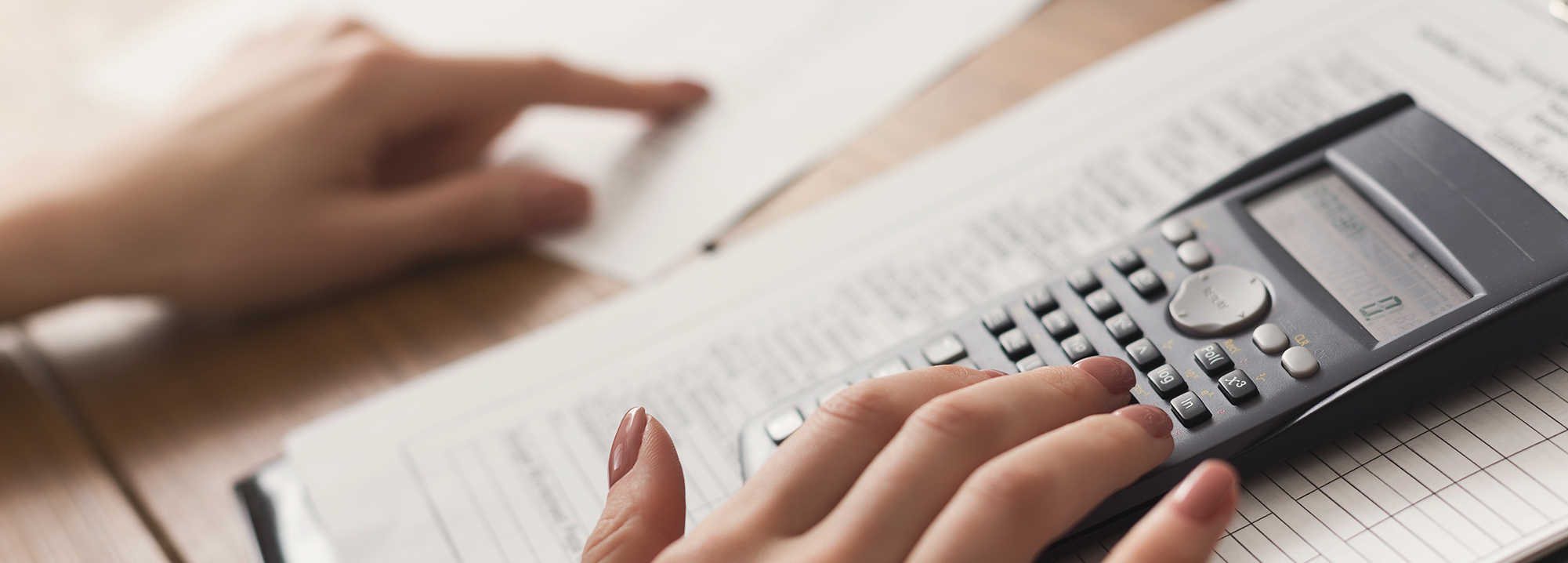 when to trade in your vehicle at Superior Toyota in Erie | Woman calculating financial expenses Woman calculating financial expenses