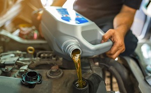 Service technician doing an oil change on a vehicle