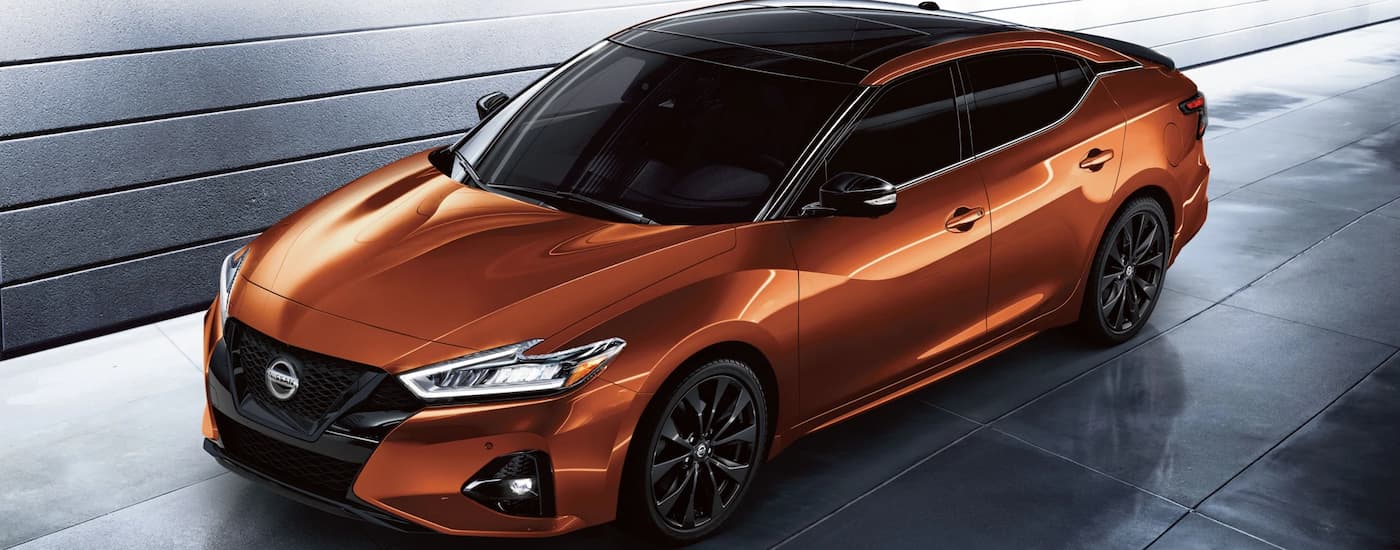 Birdseye view of an orange 2022 Nissan parked outside of a Nissan dealer near you