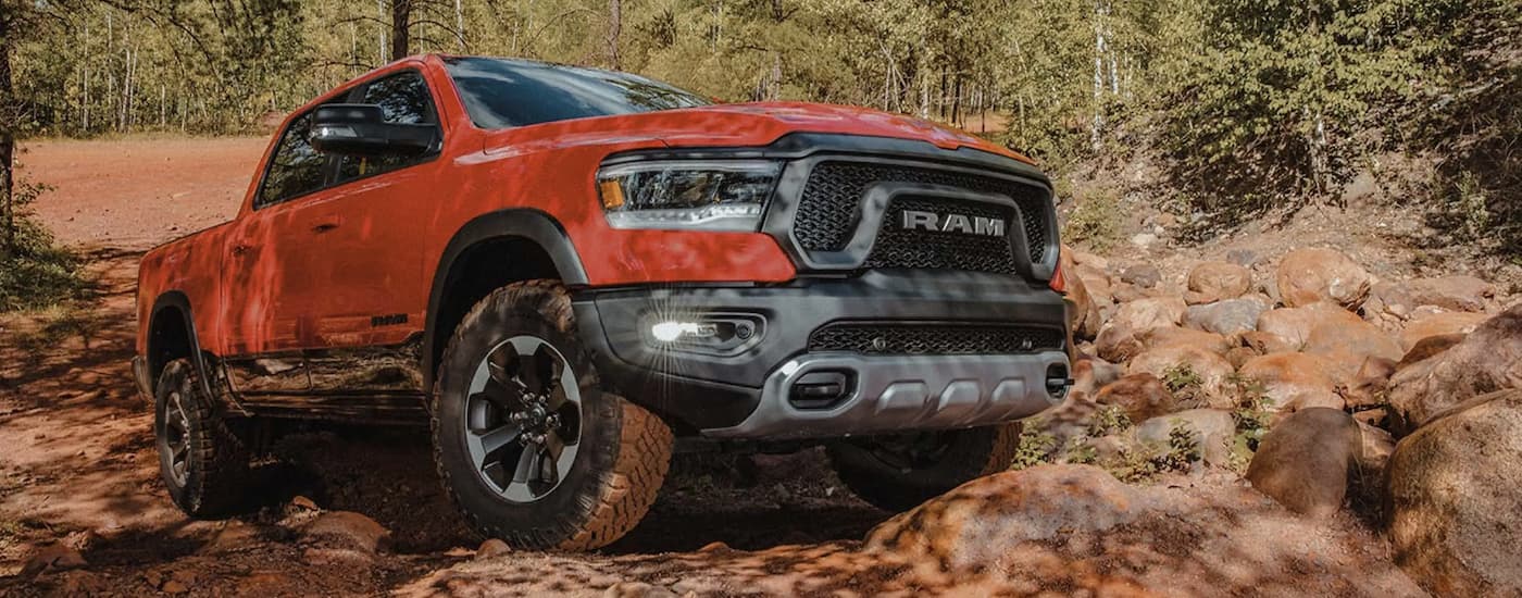 A red 2022 Ram 1500 is shown from the front parked in on a pile of rocks.