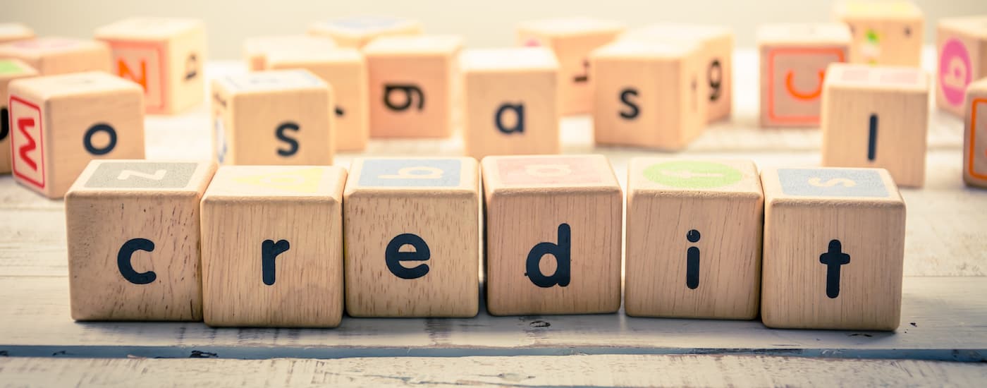 Letter blocks spelling out the word 'credit' in front of other letter blocks