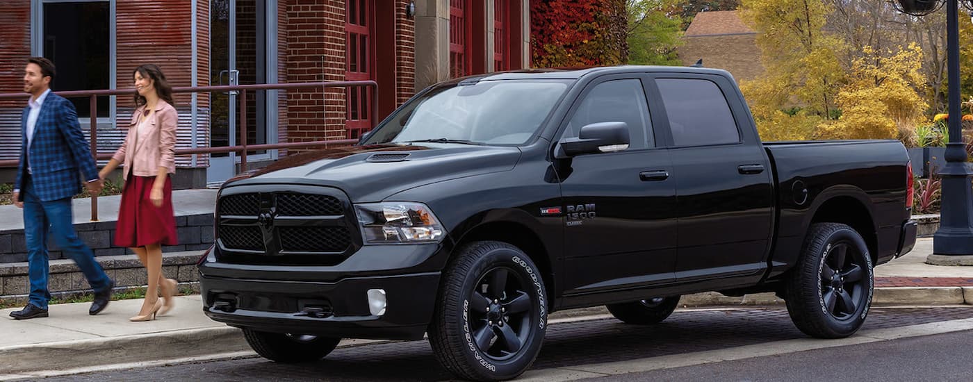 A black 2021 Ram 1500 Classic is shown parked on the side of a city street.