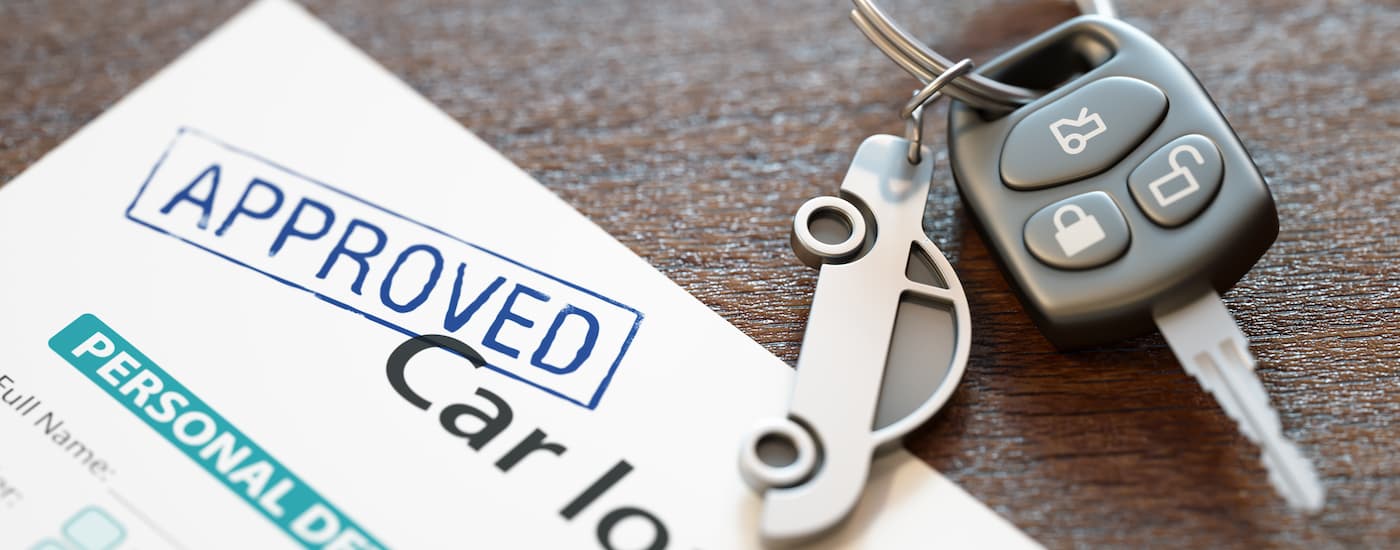 Car keys on a desk next to an approved auto loan in Edmonton
