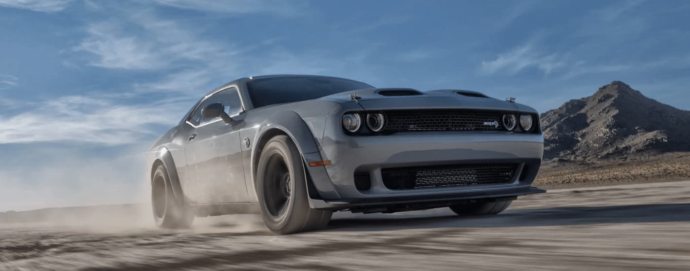 A grey 2022 Dodge Challenger SRT Super Stock is shown driving on an open road.