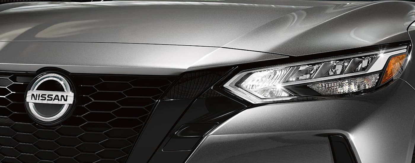 Close up of the grille and driver's side headlight on a silver 2022 Nissan Sentra Midnight Edition