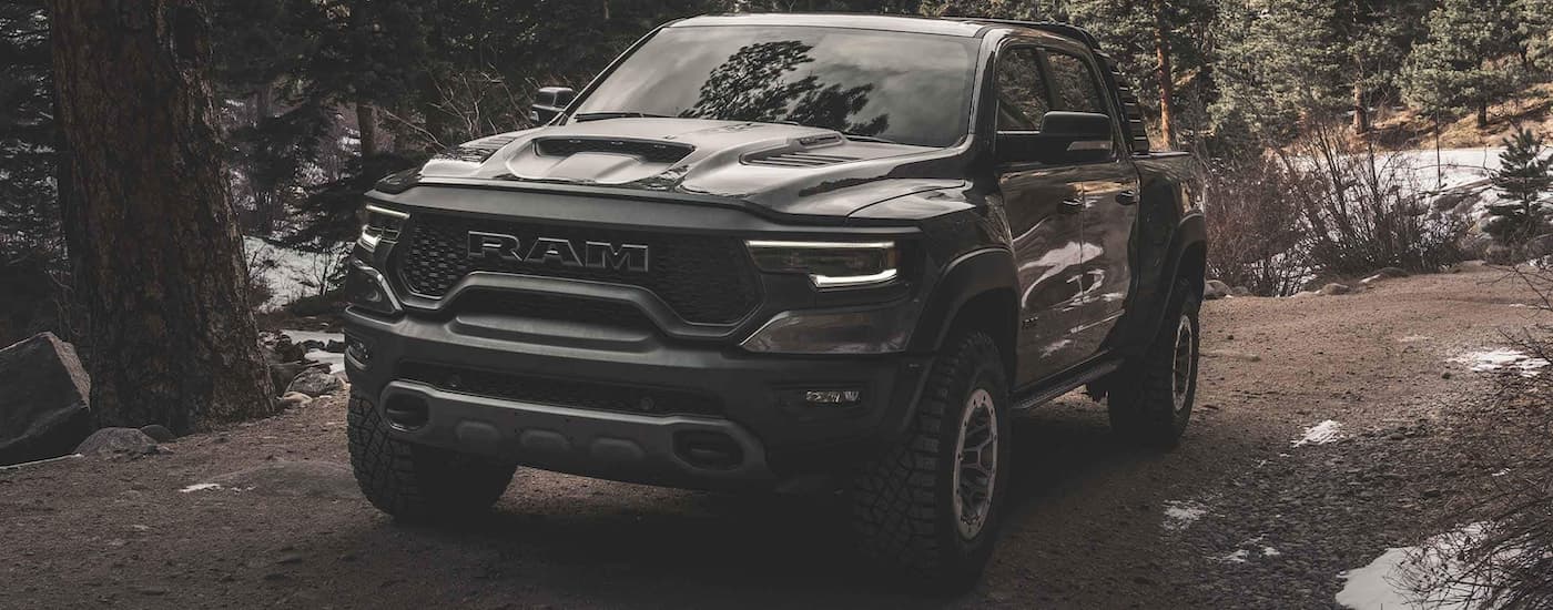 A grey 2021 Ram 1500 TRX is shown parked in the woods.
