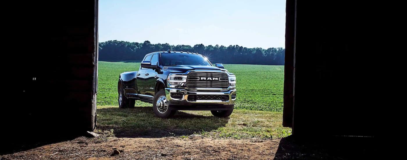 A black 2020 Ram 3500 is shown parked outside of a barn.