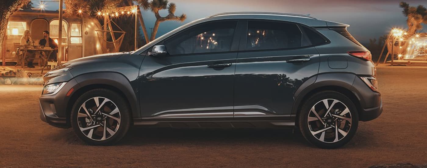 Side view of a black 2022 Hyundai Kona parked by a campsite after leaving a car dealer near you