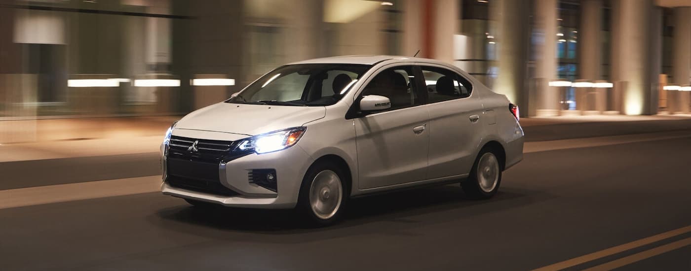 A white 2022 Mitsubishi Mirage G4 is shown driving through a tunnel after leaving a car dealer in Edmonton.