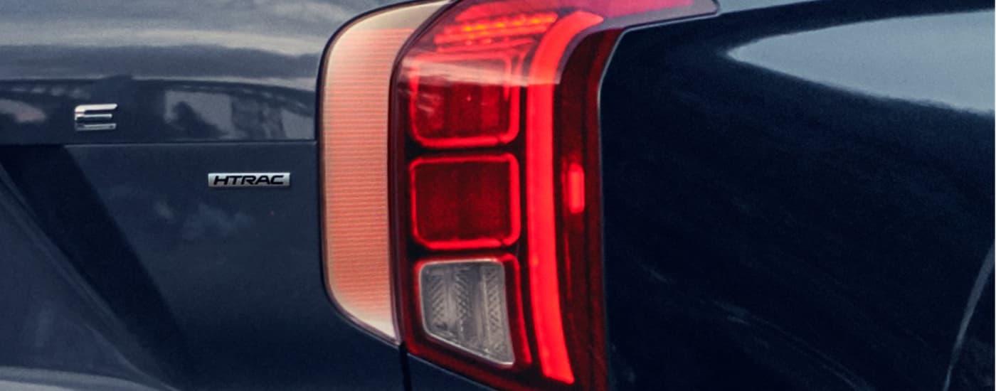 A close up shows the passenger side taillight on a dark blue 2022 Hyundai Palisade Calligraphy.