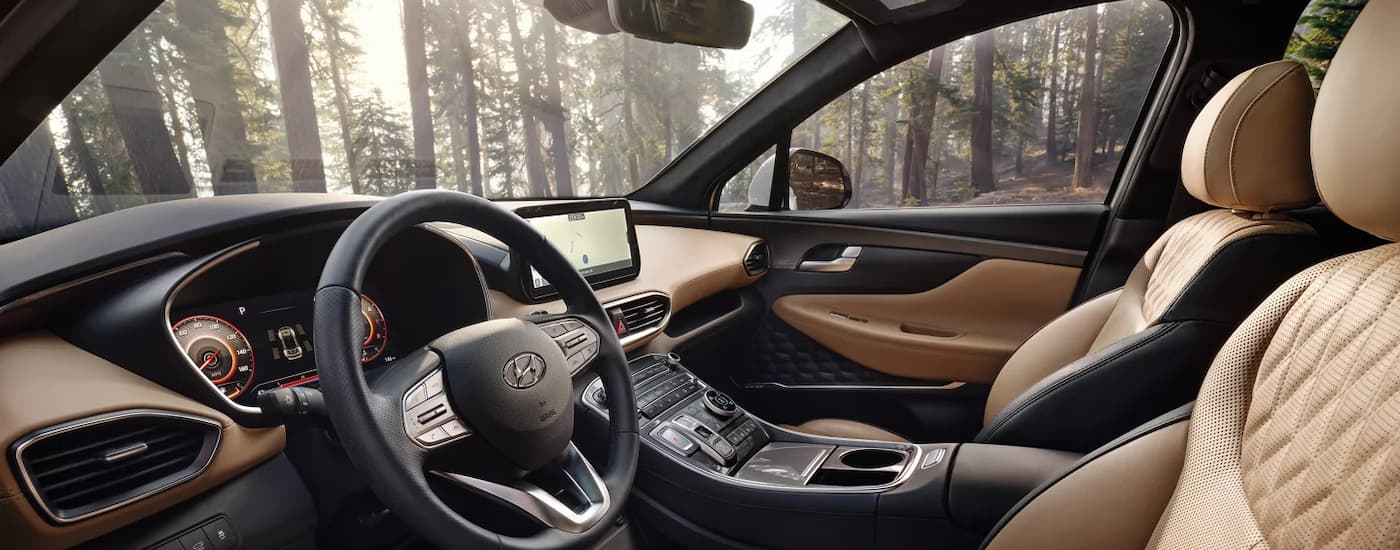 A popular Hyundai SUV, the black and tan interior of a 2023 Hyundai Santa Fe is shown.
