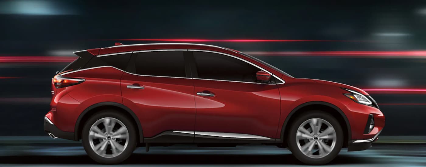 A red 2022 Nissan Murano is shown from the side driving through a tunnel.