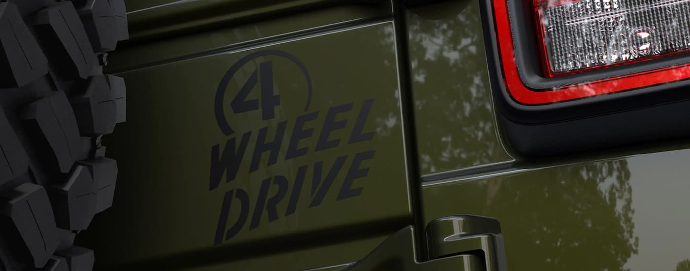 A close up of the rear headlight on a green 2022 Jeep Wrangler for sale is shown.