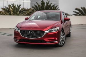 red 2018 mazda6 vehicle on cement