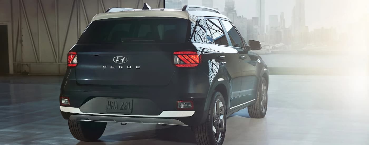 A blue 2022 Hyundai Venue is shown from a rear angle in a parking garage.