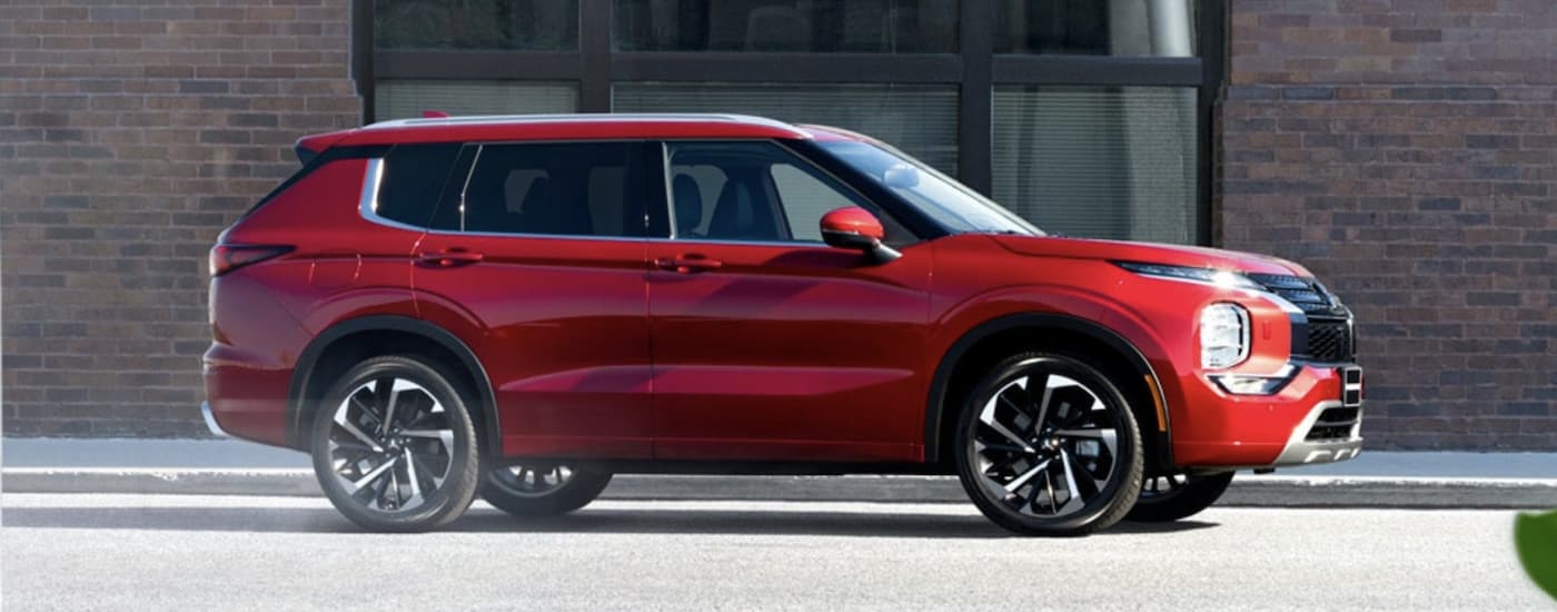 A red 2022 Mitsubishi Outlander is shown from the side.