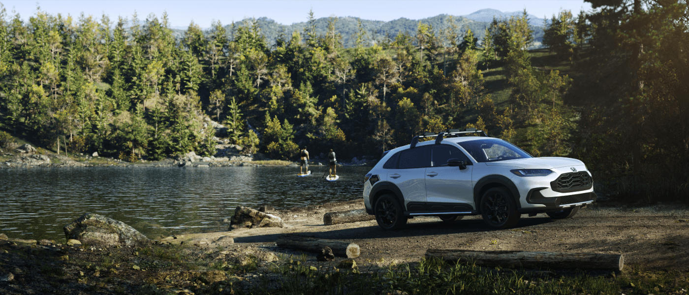 2023 Honda HR-V parked by a lake with paddleboarders
