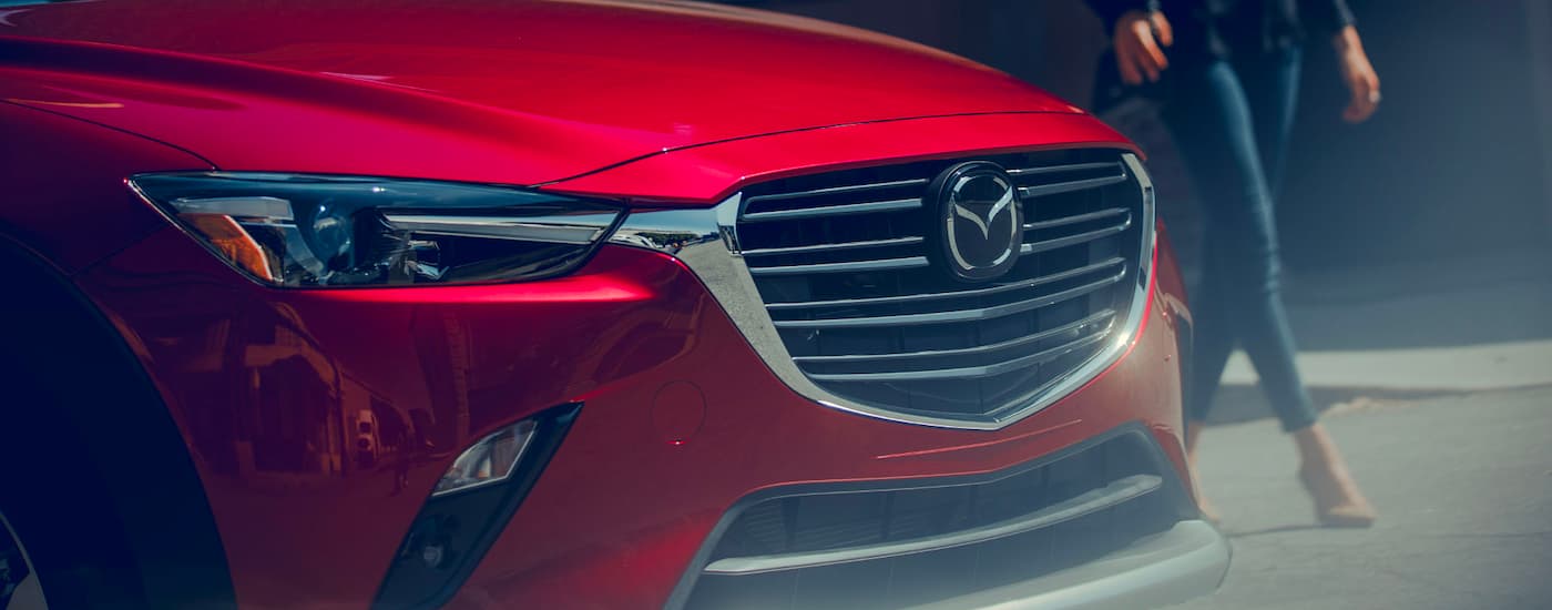 A close up shows the grille on a red 2019 Mazda CX-3.