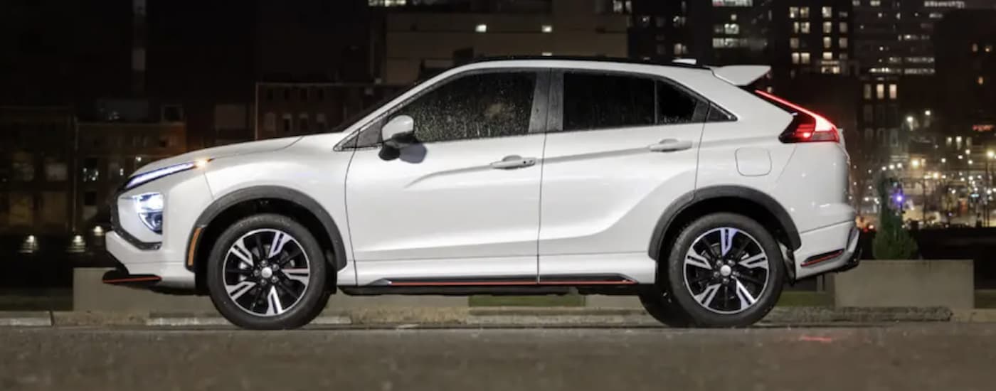 A white 2023 Mitsubishi Eclipse Cross is shown from the side.