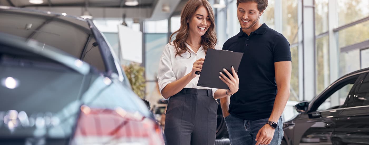 A saleswoman is shown speaking to a customer about bad credit car loans in Edmonton.