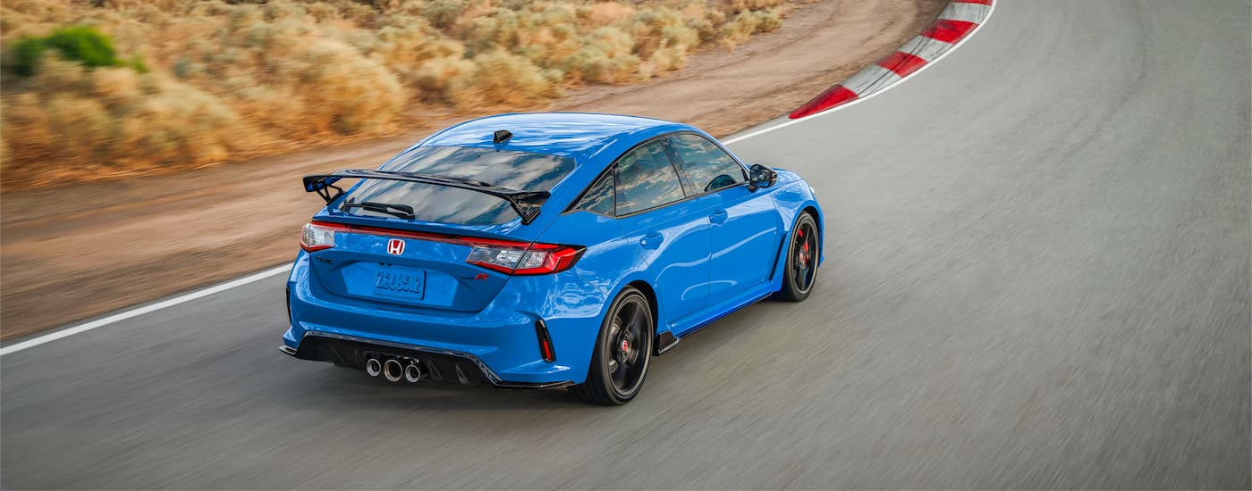 Aerial view of a blue 2023 Honda Civic Type R driving on a race track.
