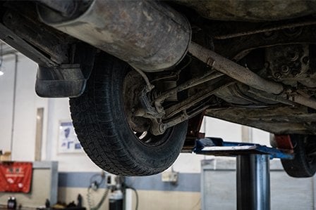 Muffler being worked on at car repair facility on Long Island, NY.