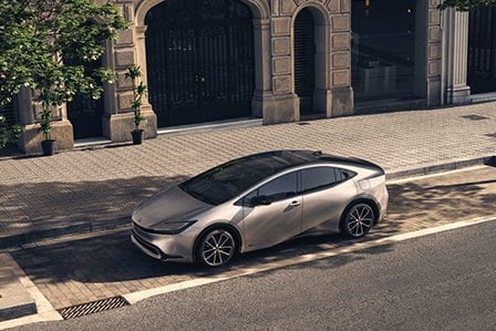 Silver Prius parked on Long Island, NY, street.