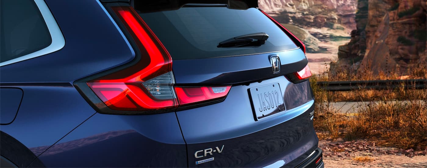 A close up of the rear lift gate on a dark blue 2023 Honda CR-V Hybrid Sport Touring.
