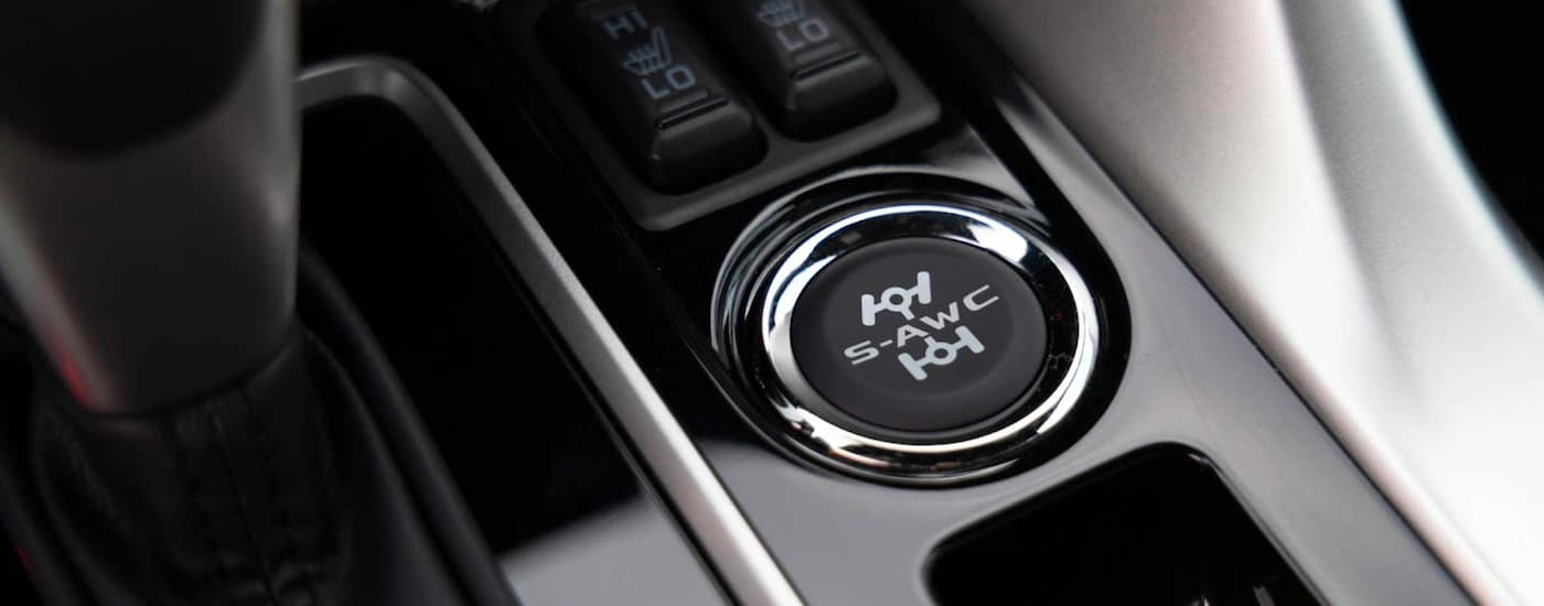 The 'S-AWC' button is shown on the shift panel in a 2023 Mitsubishi Eclipse Cross.