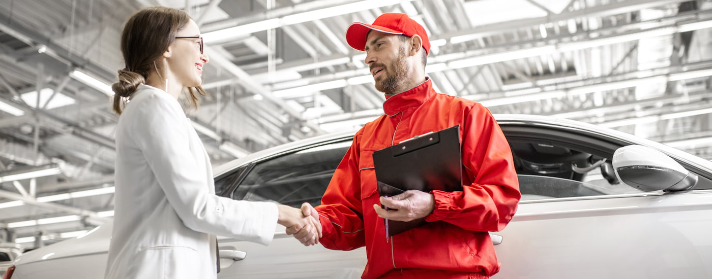 A person is shown shaking hands with a mechanic.