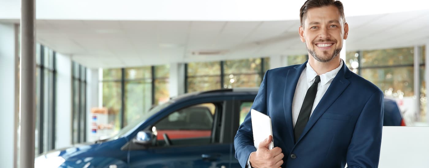 A salesperson is shown holding a clipboard.
