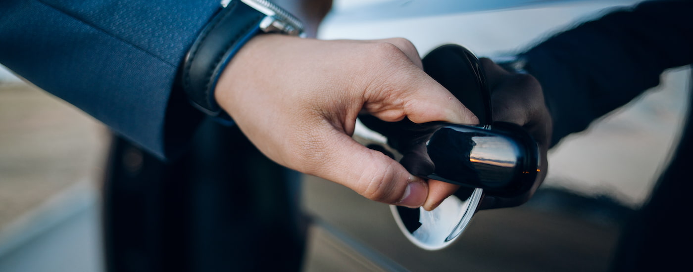 A person is shown opening a car door.