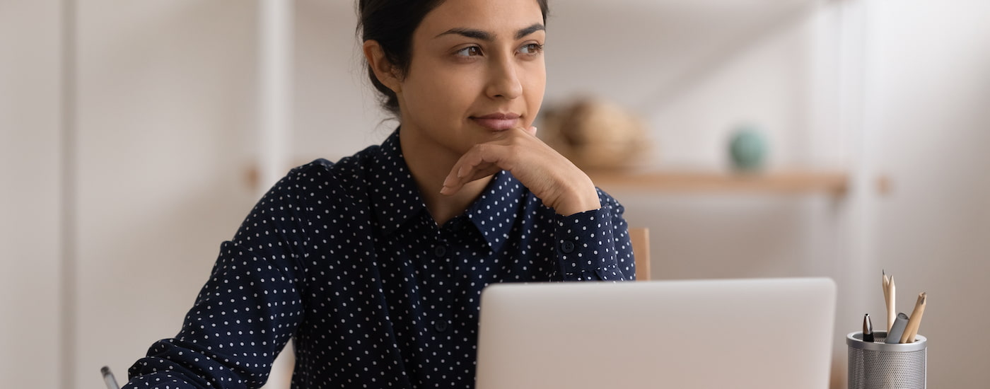 A person is shown working on a laptop to create a listing after searching "sell my car."