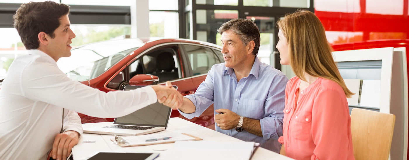 Two people are shown talking to a salesperson about bankruptcy auto loans Edmonton.