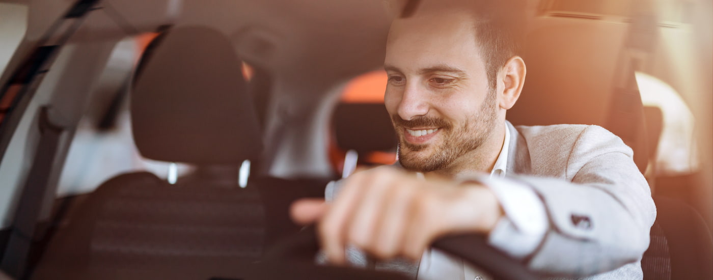 A person is shown driving a vehicle after searching "sell my car."