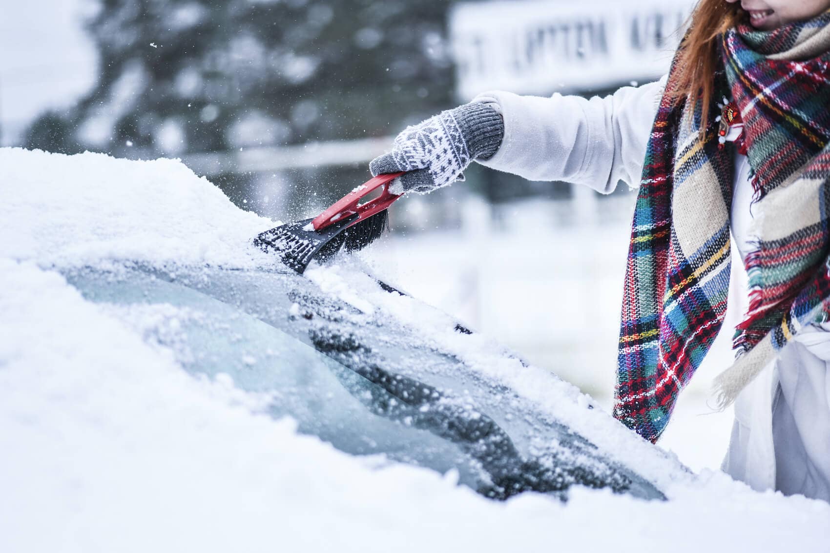 Scraping snow and ice off windshield