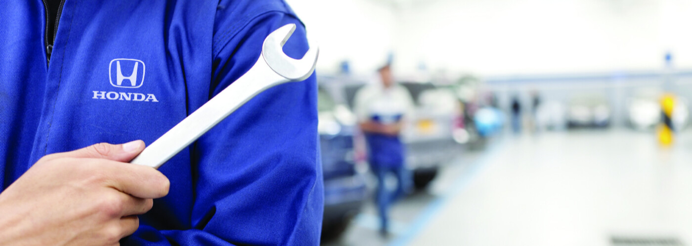 Honda service tech holding wrench