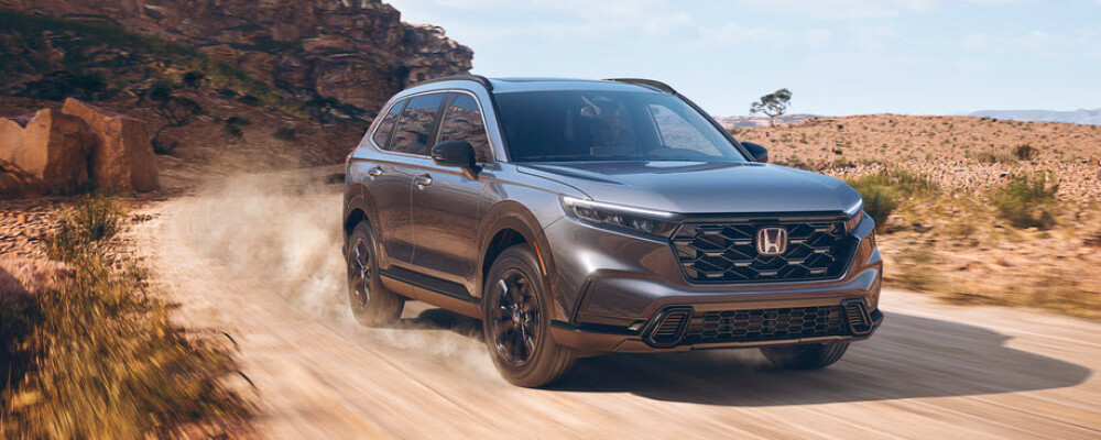 2023 Honda CR-V Sport driving down the trail