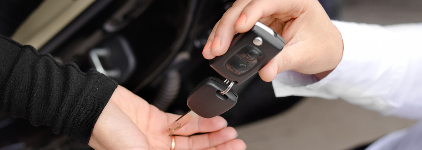 Woman handing over car keys