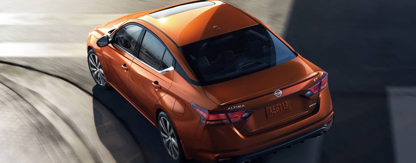 An orange 2022 Nissan Altima is shown from above on a city street after leaving a Beloit, IL Nissan dealer.