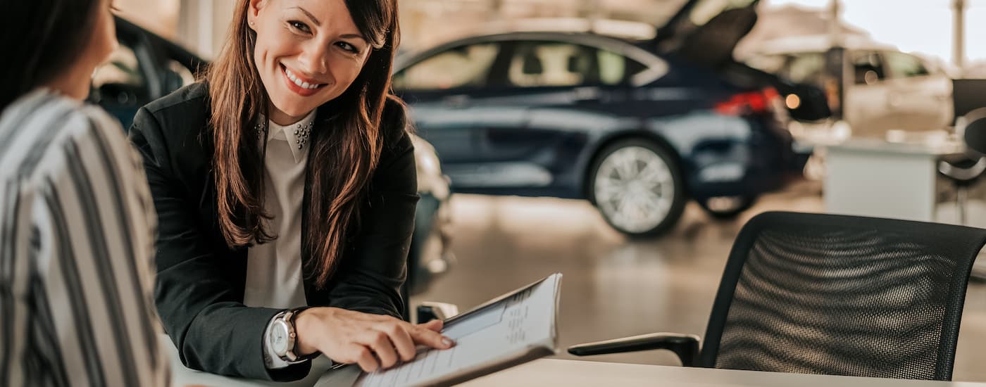 A salesperson is shown going over information with a customer.