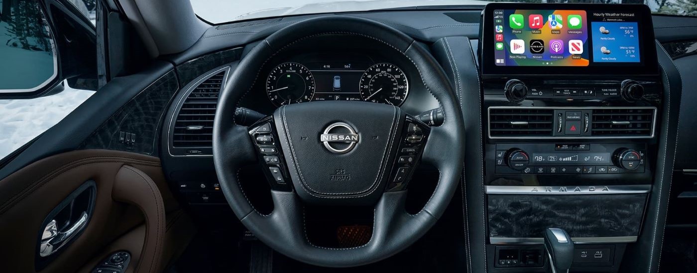 A close up shows the dash and infotainment screen in a 2023 Nissan Armada for sale.