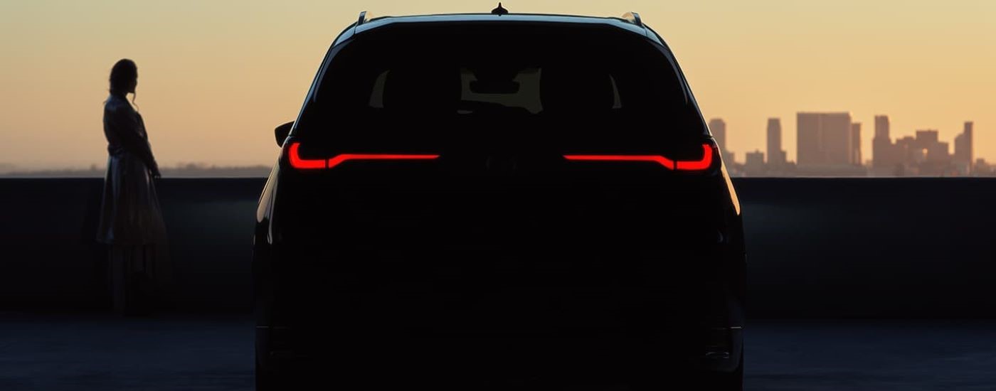 A close up shows the illuminated taillights on a black 2024 Mazda CX-90.