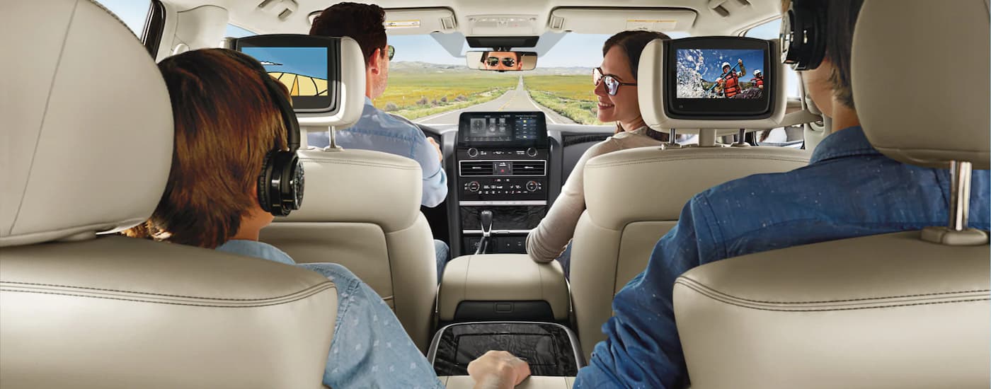 A family is shown driving in a 2023 Nissan Armada on a road trip.