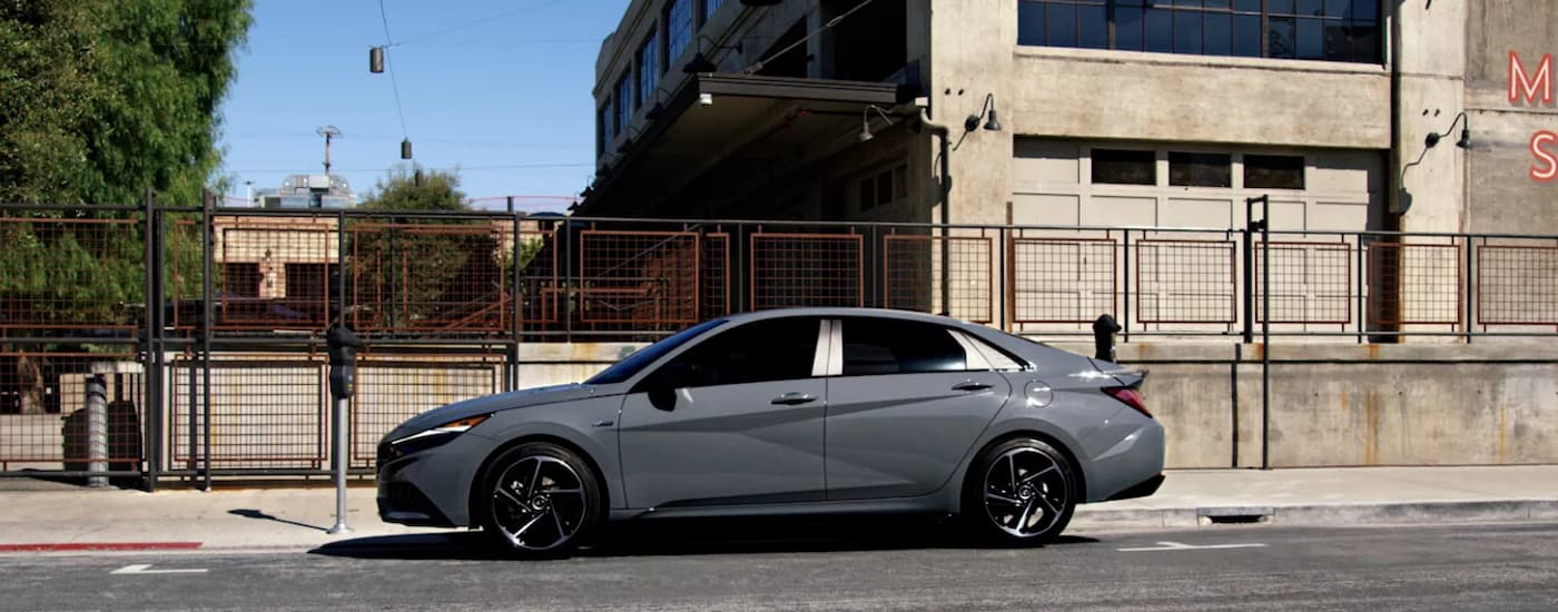 A grey 2023 Hyundai Elantra N-Line is shown from the side parked on a city street.