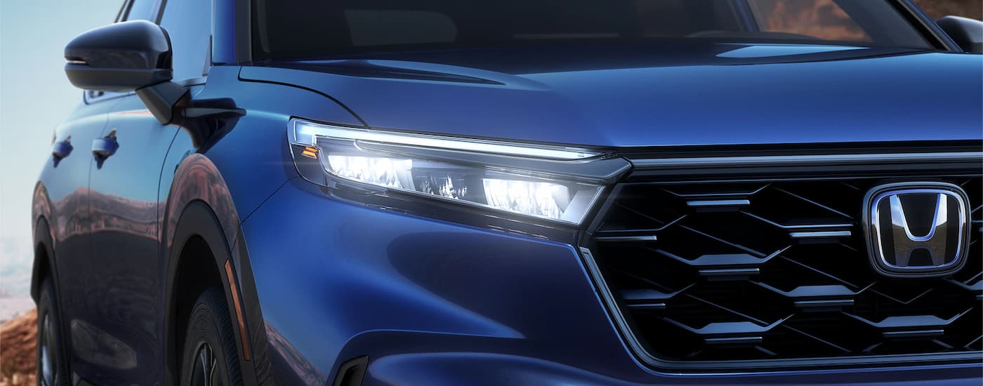 A close up of the headlight and grille on a 2023 Honda CR-V is shown.