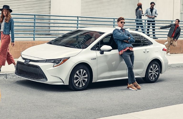 man leaning on 2021 Toyota Corolla Hybrid